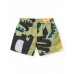 Boys' swim shorts with a green, black, and yellow print 